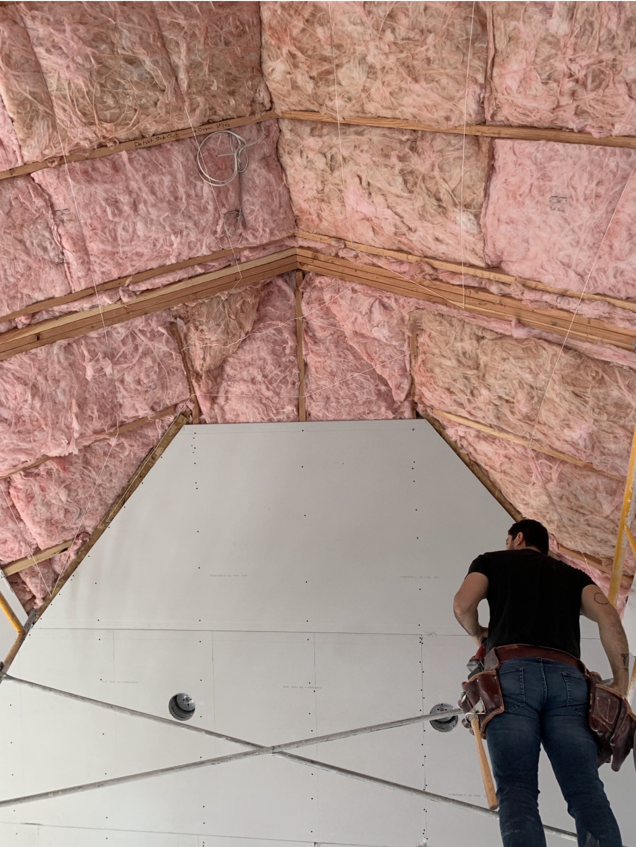 Ceiling drywall installation with fresh insulation on a Portland project